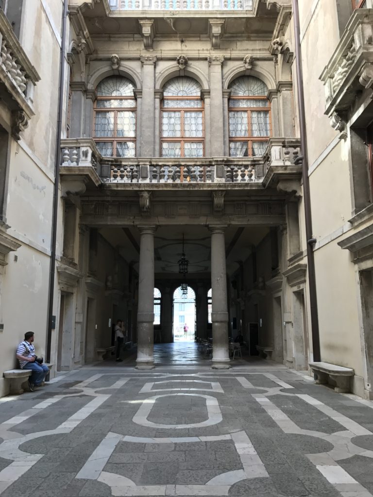 The courtyard of the Ca'Rezzonica Palace in Venice. The upper two floors on one side are converted to a grand ballroom.