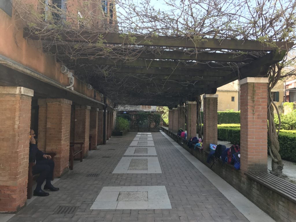 A covered walkway in Ca'Rezzonica Palace garden in Venice.