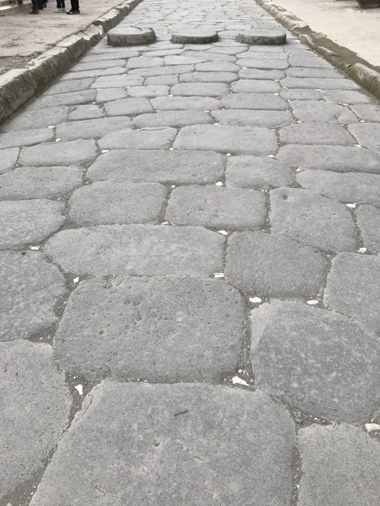 A road with marbles in the joints. Imagine visiting Pompeii back then.