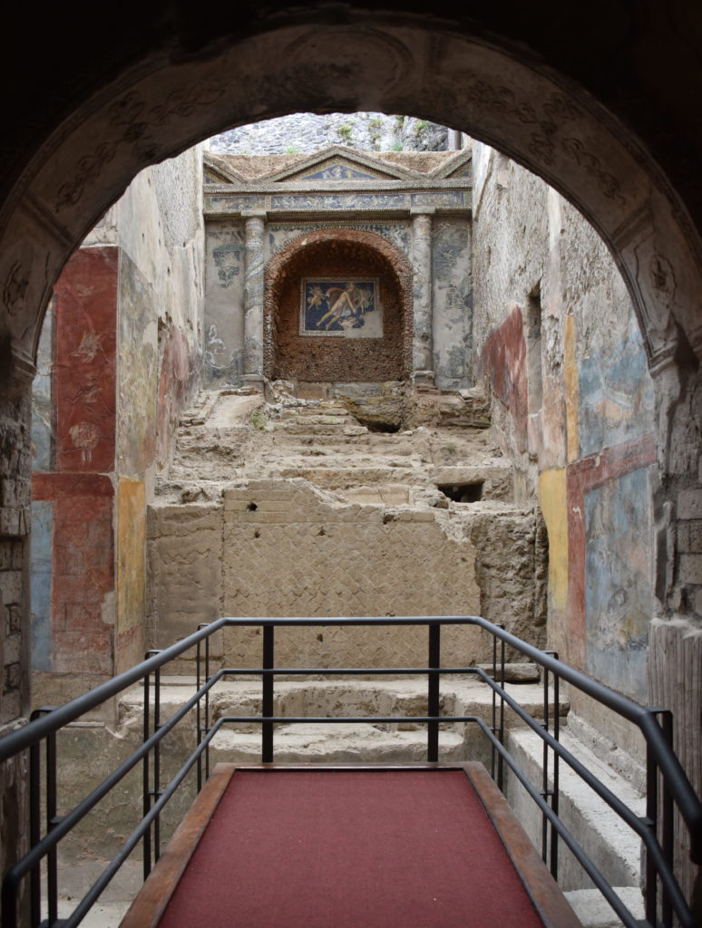 This bath in Pompeii shows some fancy tile work at the head of the pool and a waterfall that feeds hot water into the pool. Paintings on the pool walls depict ocean scenes with exotic sea creatures, making the room looks larger and more relaxing. The blue color derived from seashells is still intact after over 2000 years!