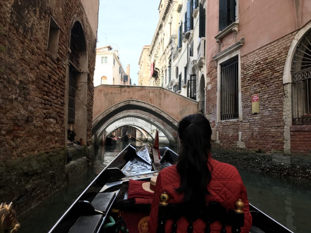 Going under many bridges on a gondola in Venice.