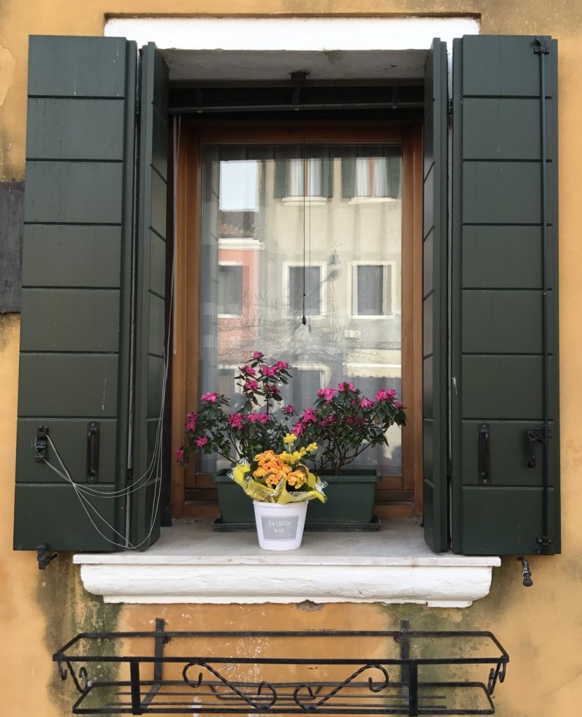 Houses in Venice and surrounding islands have these interesting shutters that look beautiful when open and help the room go dark when shut. Very functional, sturdy and artistic window covering. 