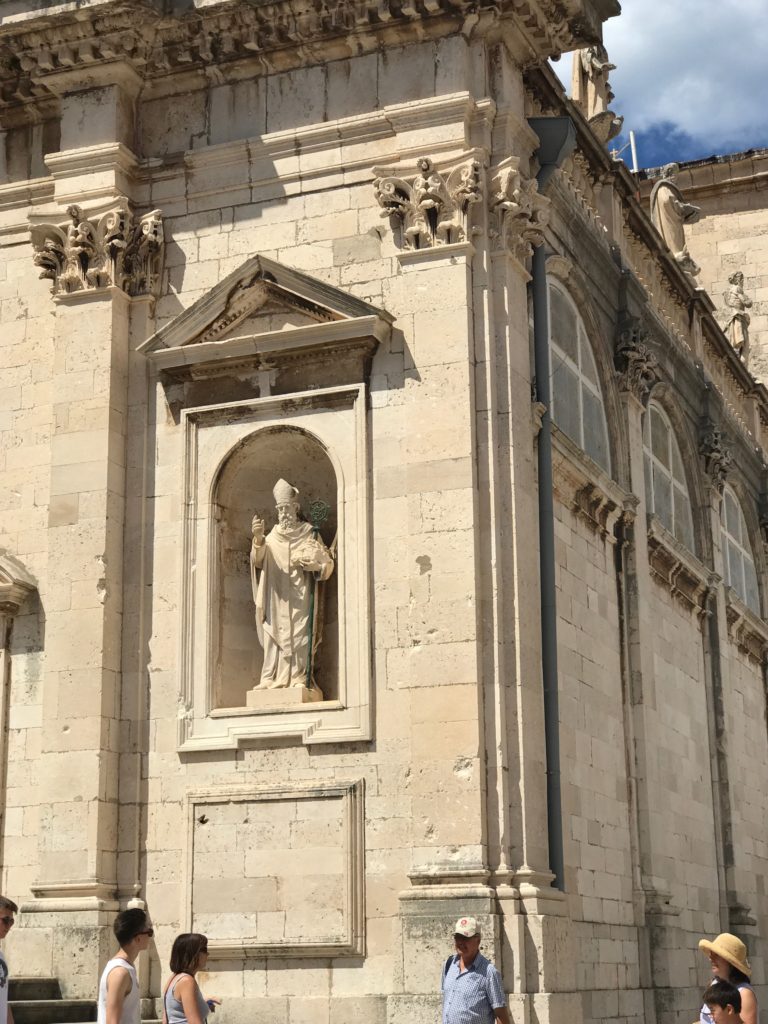 Saint Blaise's statue outside the St Blaise church (can be found all over the island). He always has a small replica of the Dubrovnik old city in his hand. 