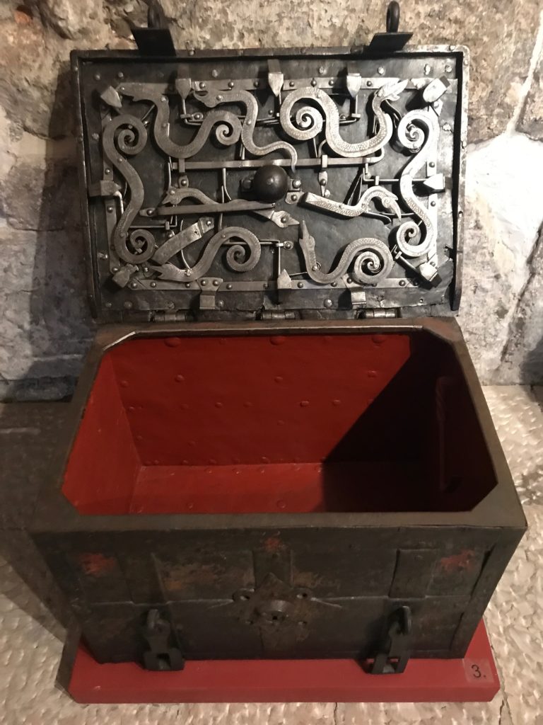 A portable iron chest showing the complicated locking mechanism under the lid. While it was common in Europe in those centuries, very few remain. Each of the chests on display is unique in its design and locking mechanism. 