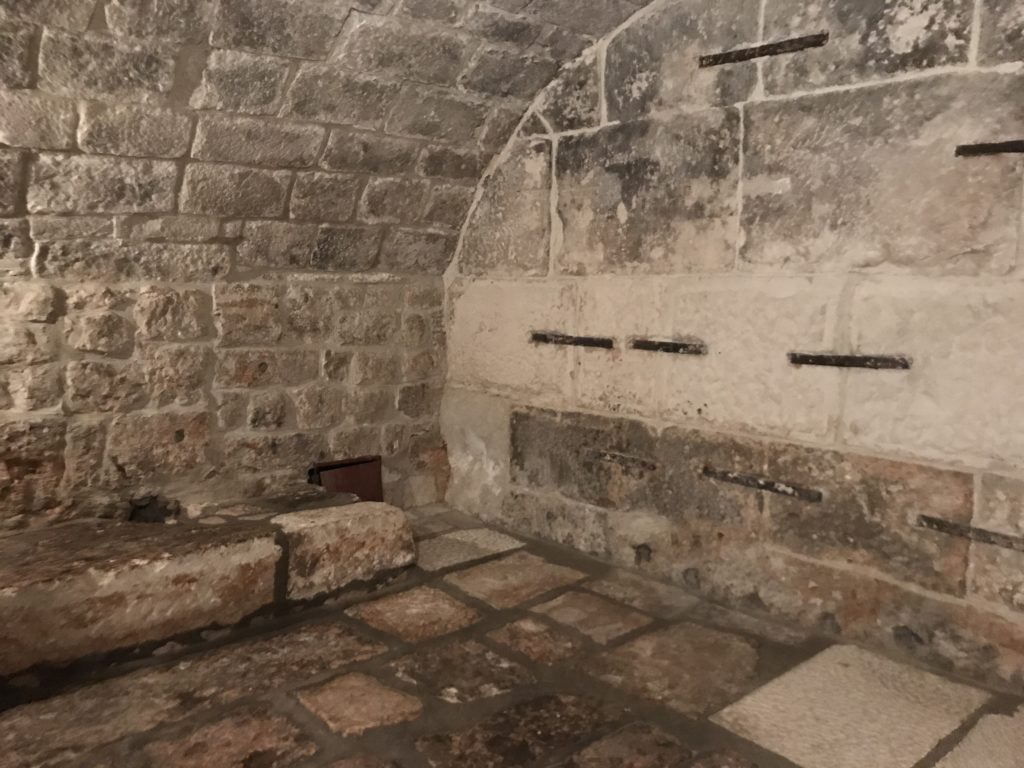 The dungeon is pretty small and depressing with a tiny door and a tiny window, all set behind another wall in the basement of the Rector palace. 