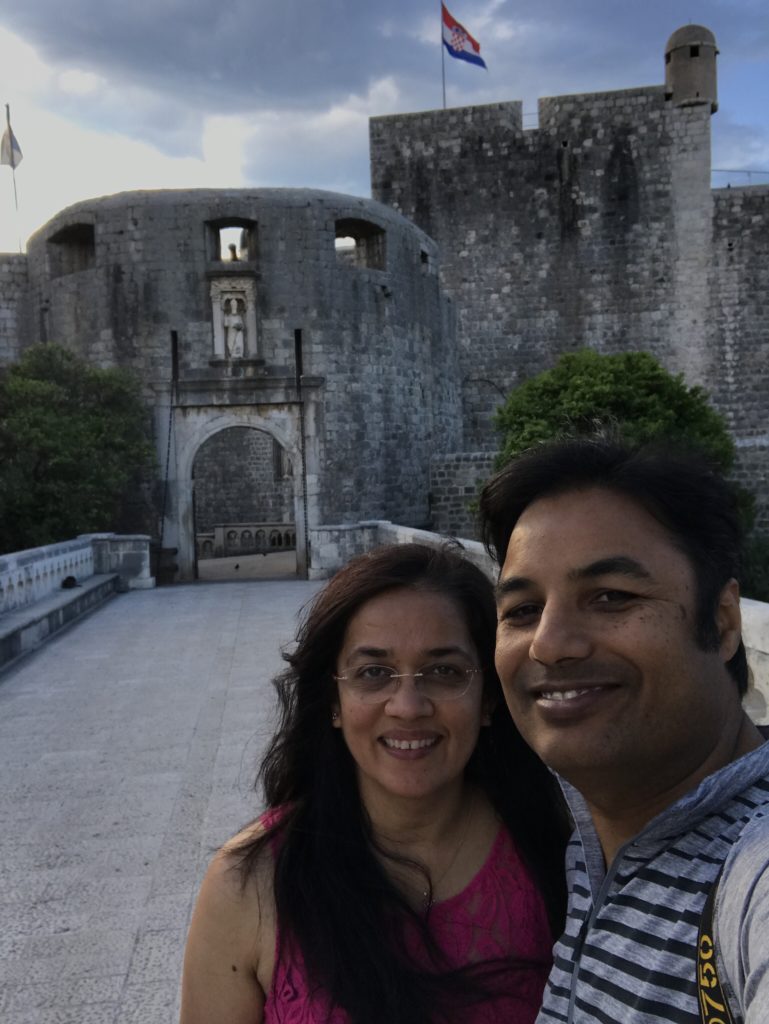 Selfie at the main entrance of Dubrovnik old town, marked by the moat and a big gate. 