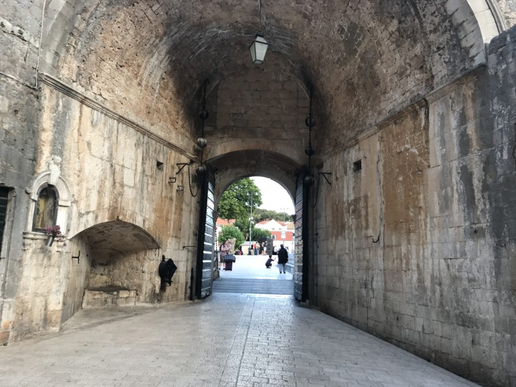 Looking out from the old town to the rest of Dubrovnik. Notice the machinery used to operate the main gate. 