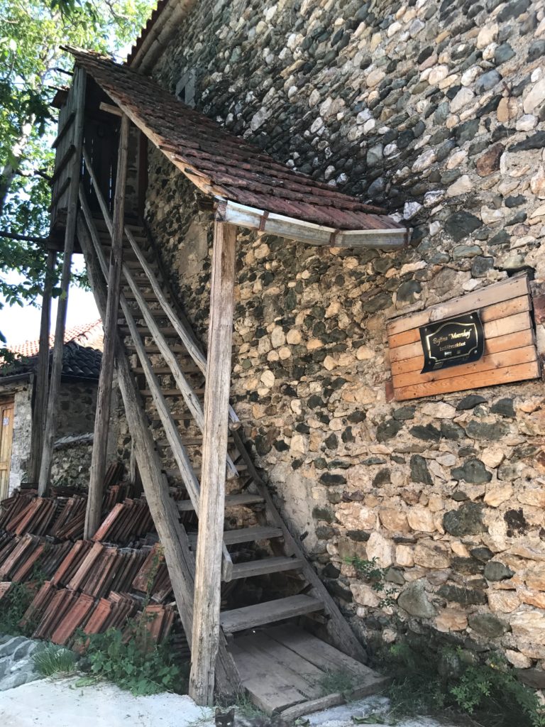 Exterior stairs leading up to the third floor. The third floor also has a direct entrance from the street, so guests can be welcomed on the third floor without passing through the residence. People in this village, even elderly, must be very fit to be climbing steps all the time.