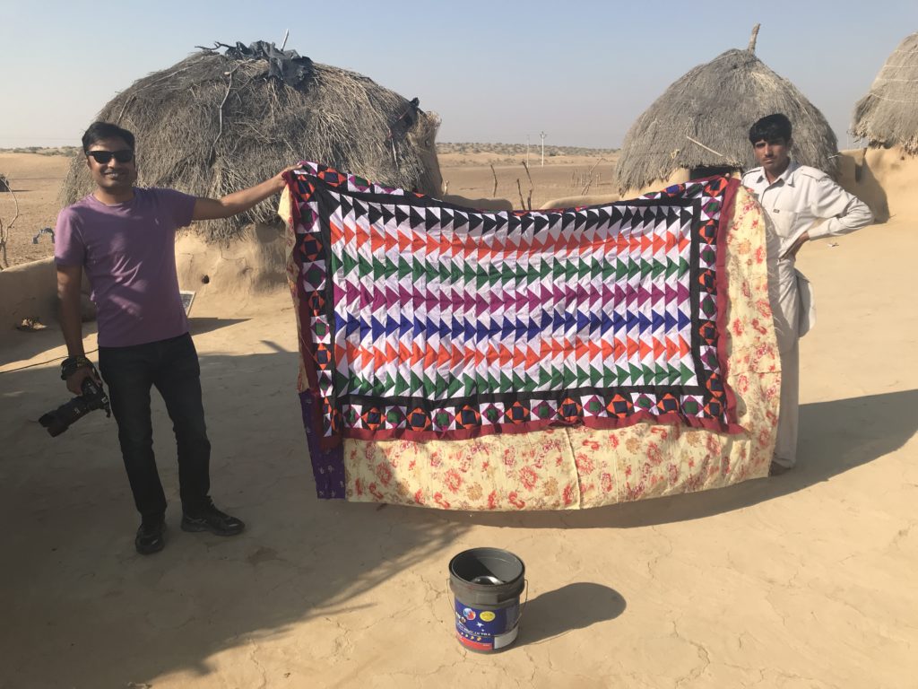 Raiees showing us a floor rug his mom is working on, for his sister’s dowry. It’s a quilt made with pieces of fabric, sewn entire by hand using only scissors, needle and thread. 