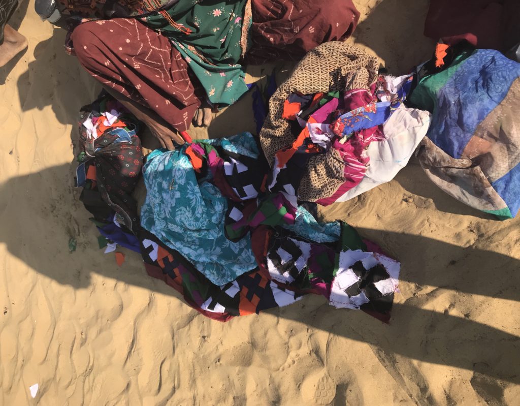 Raiees’s mom transforming a pile of colorful fabric into a beautiful quilt. 