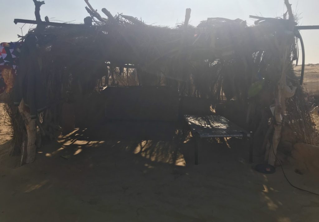 A modest living room with protection from the sun and breeze. But on this pleasant summer afternoon the mom & daughter prefer to sit in the sun. 