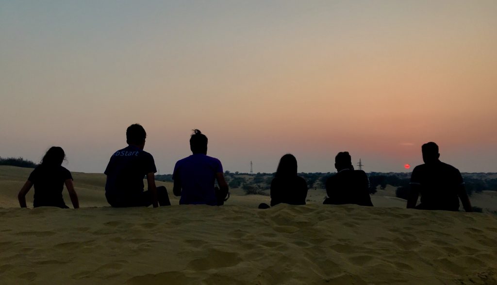 The gorgeous desert sunset. Temperature in the desert drops with the sun. We noticed the sand behind us was cold while in front of us, it was still warm from the setting sun. As the sun disappeared, it got chilly, so we rushed back to the car shivering. 