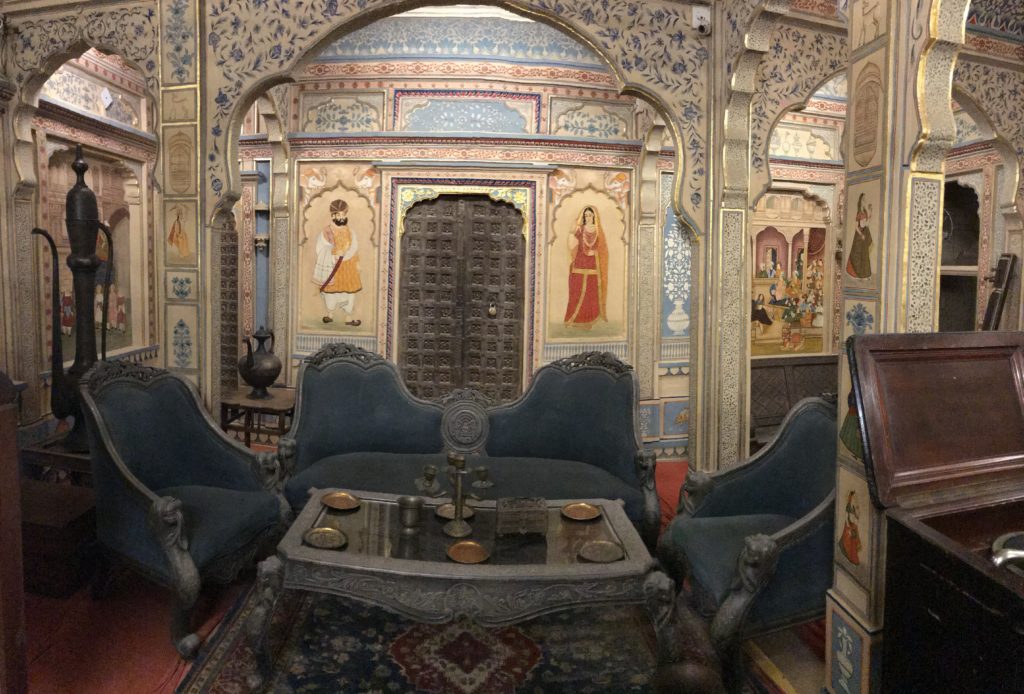 The formal sitting room has many sources of entertainment, such as a record player, sitar, hukka etc. 