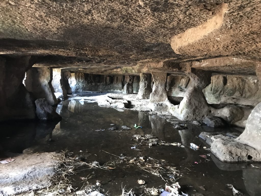 These are the remains of what used to be stables once upon a time. It must have been impressive when carved inside the mountain. The grooves in the big pillars are probably from the ropes used to tie horses. Unfortunately today it lies abandoned and littered with plastic bottles and bags.