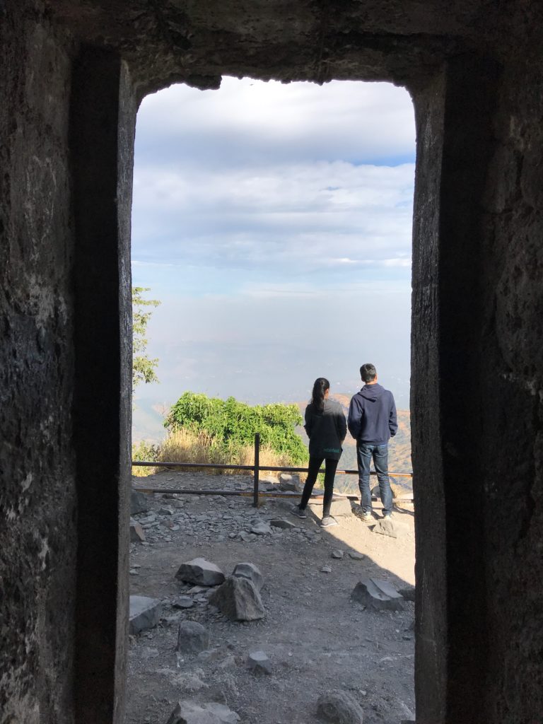 Looking outside a guard tower at the edge of a mountain, a wonderful place to take off on wings into the clouds.