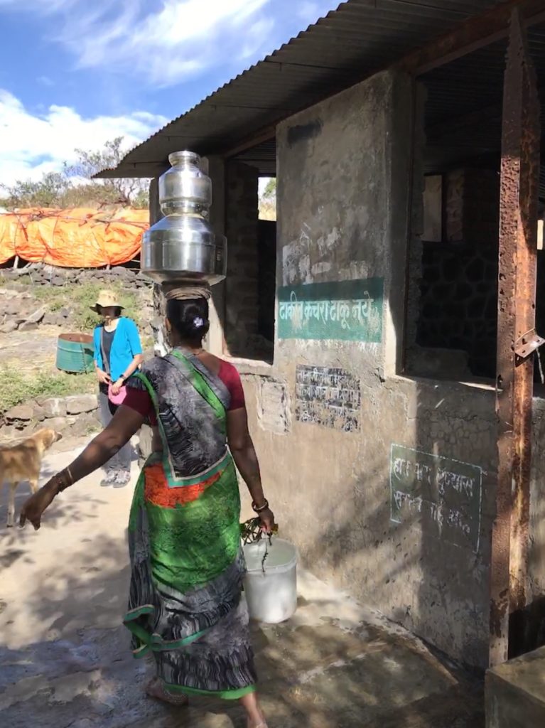 A woman takes water for her family.