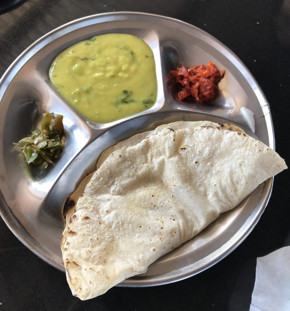 This is a simple and delicious meal in Sinhagad fort or bhakri, pithle, onion pickles and a veggie. Most vendors offer the more elaborate thali too but we liked this one better.