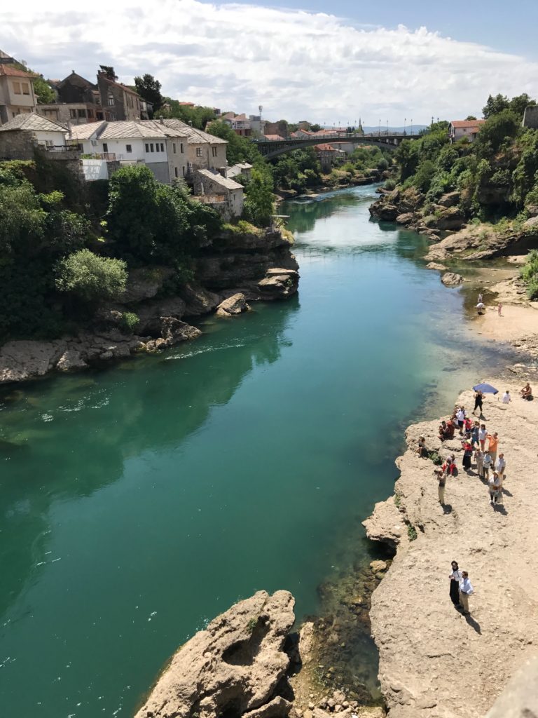 Spectators gather on the Mostart bridge and by the river in anticipation of the guy promising to jump from the top of Stari Most into the cold river.