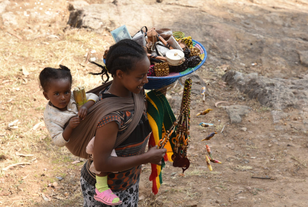 Addis Ababa: A young mother selling handicrafts to visitors atop Mt Entoto