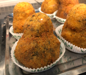 Sicilian vegetarian arancini - rice balls stuffed with spinach or mushrooms.