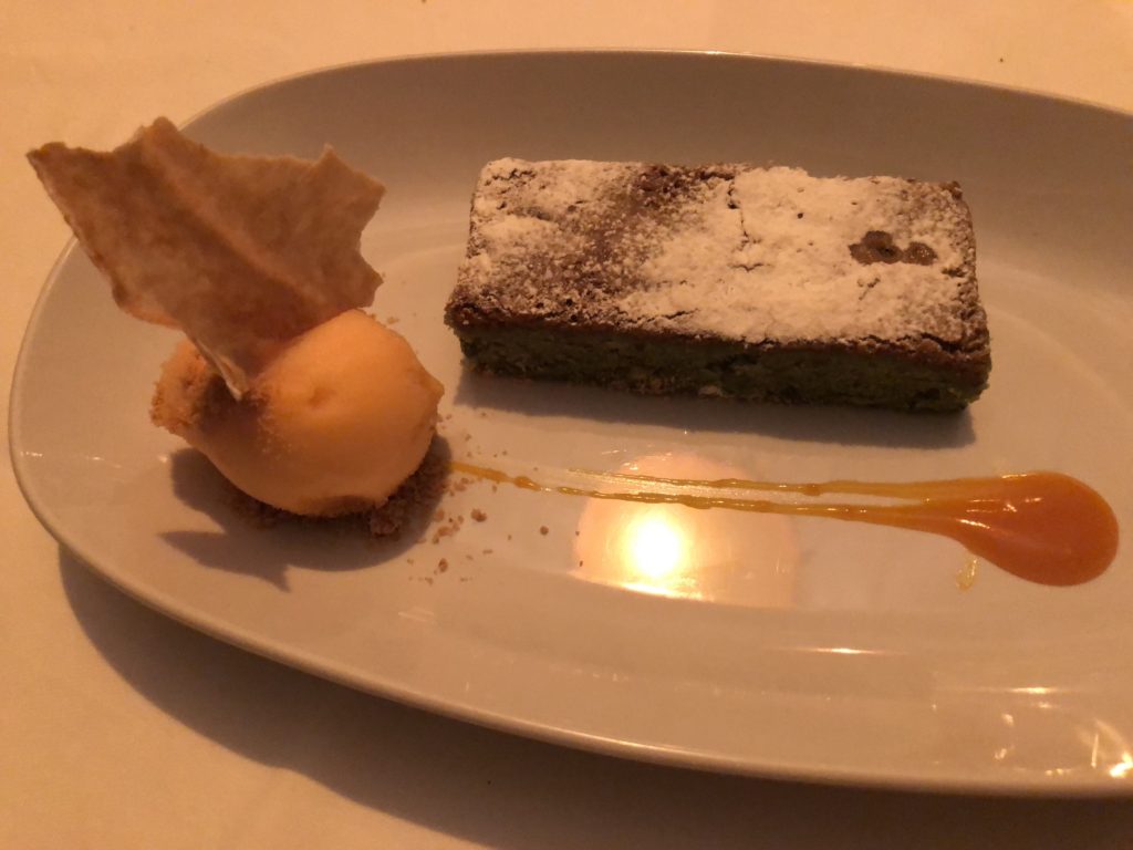 The pistachio cake served with sorbet and a sauce was absolutely amazing.