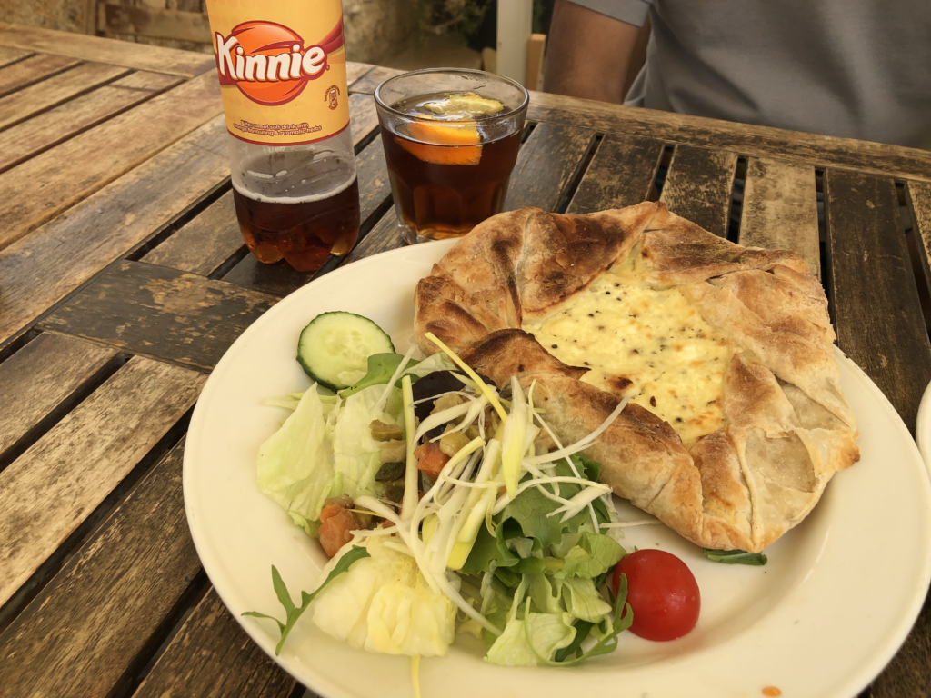 A ftira, Malta’s answer to the Italian pizza. It’s a homemade pastry lined with potatoes and sheep cheese. Served with salad and marinated vegetables. Kinney is a local drink from Gozo. 