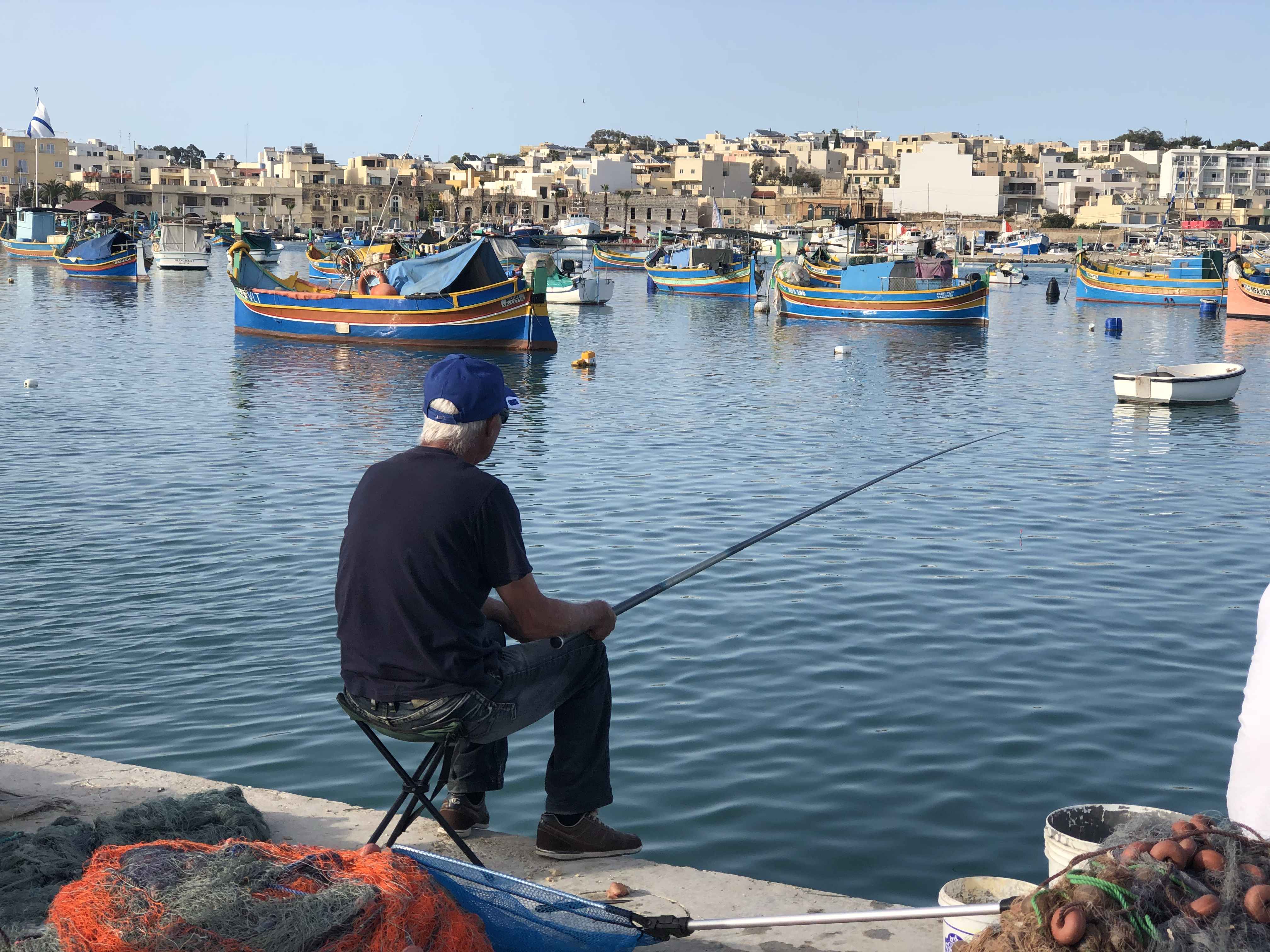 Leisurely life, sitting on the dock of the bay, fishing all day in Marsaxlokk. 