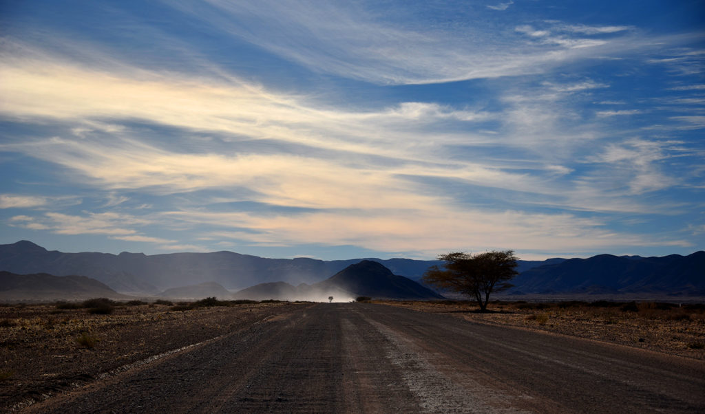 Driving along the vast, empty and open Namibian country side.