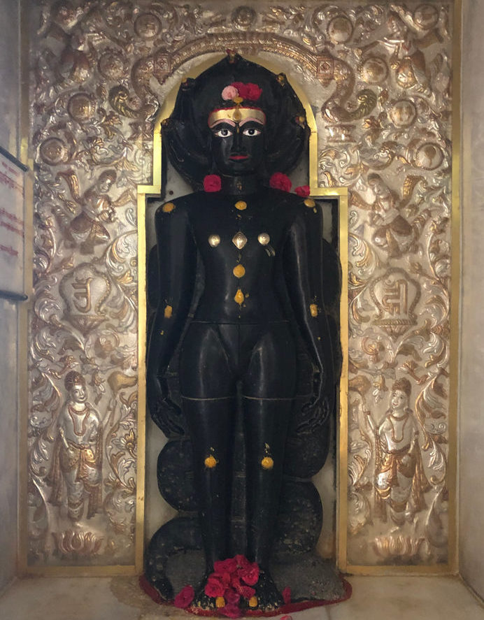 Siri Parshvnath Bhagwan's statue in Kulpakji is made of black granite rock in the usual standing posture with 5 snake fangs above his head. I was made in the 10th or 11th statue.