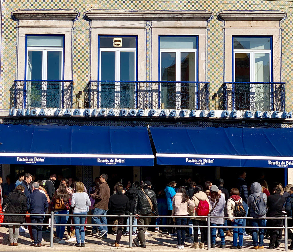 This is Pastéis de Belém near Lisbon, Portugal. This entrance to the original store is always packed with tourists and locals.