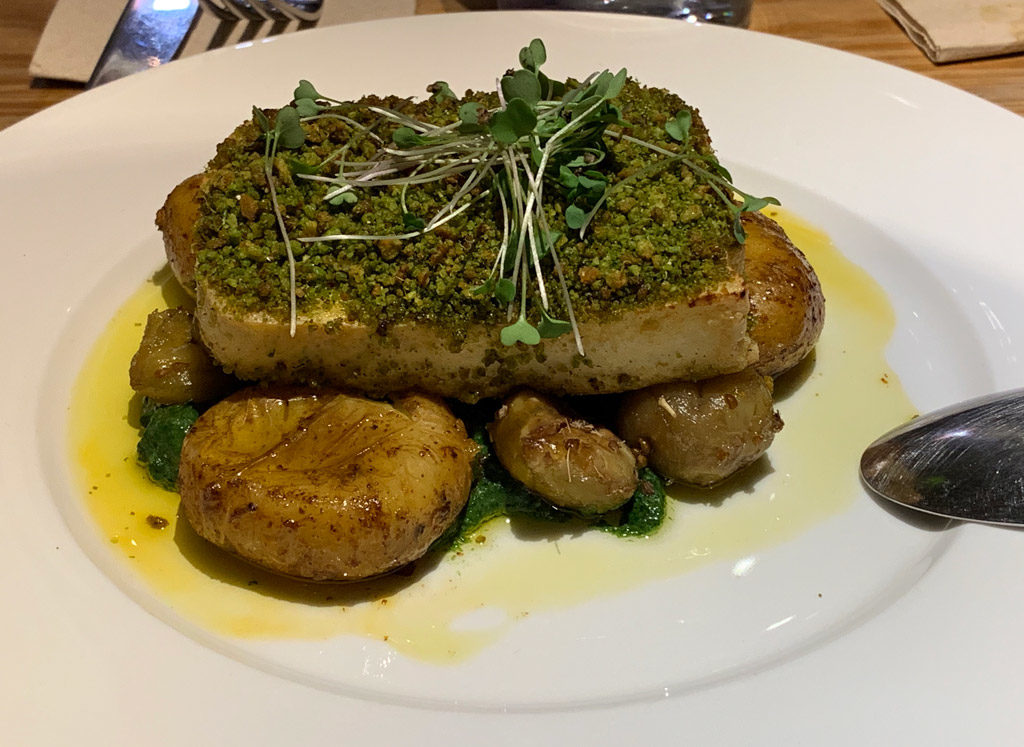 Tofu bio with crust of corn bread served on pesto and baked chestnuts and baby potatoes in Ao 26 Vegan Food Project in Lisbon, Porto.