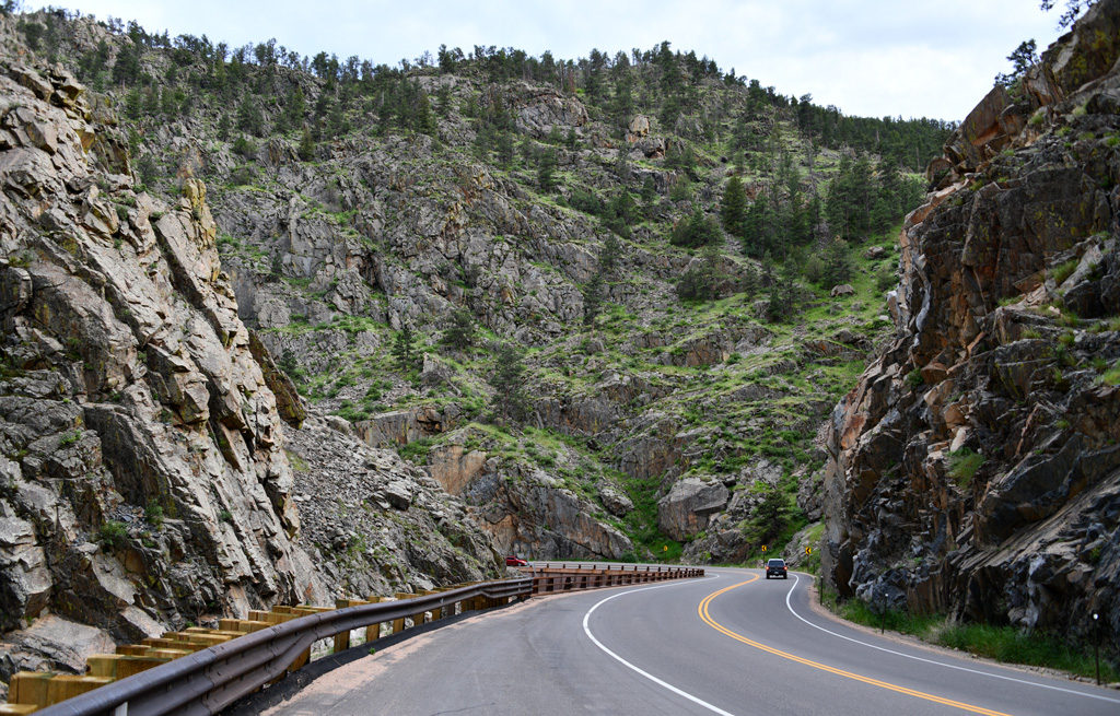 The scenic road in Drake runs along the river that carved its way through the towering rocky mountains.