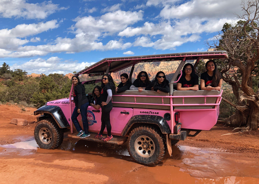 Posing on the Pink Jeep Tour during weekend spa getaways for girlfriends