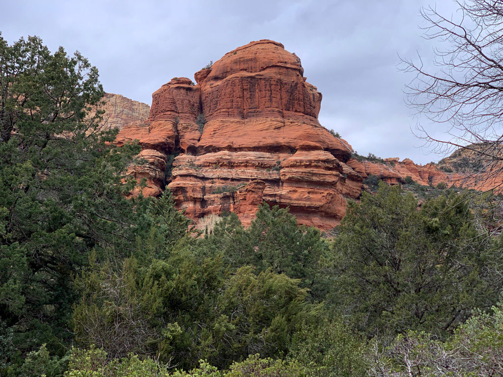 Boynton Upper Vortex Trail in Enchantment Resort and Mii Amo Spa is surrounded by trees and massive red rocks all the way.