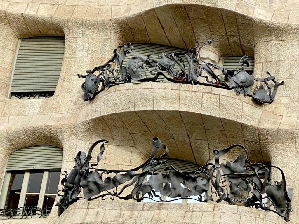 The vines that form the balcony have so much detail!  Check the forest critters on the wrought iron carved leaves and branches! This design prevails inside & outside the building.