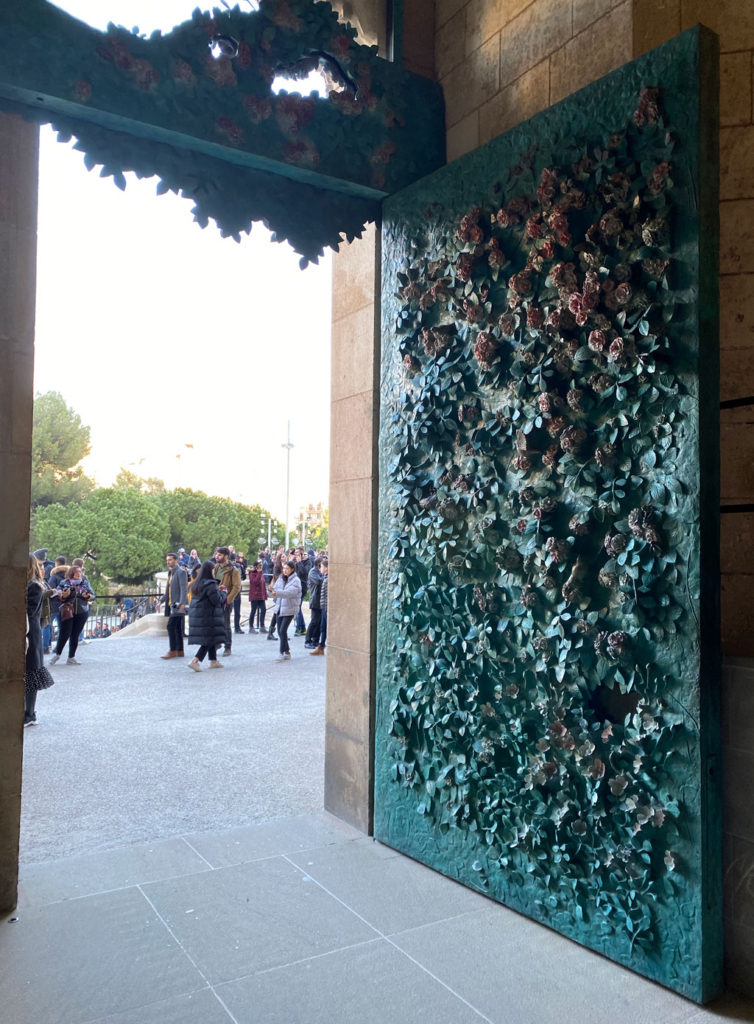 A wall of rose bushes on a beautiful side door at La Sagrada Familia.