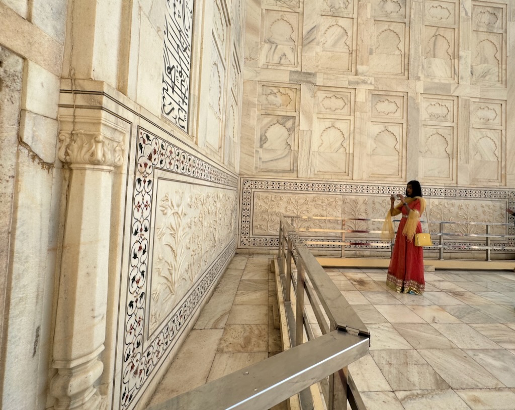 Seema admiring the detailed artwork on Taj Mahal's mausoleum.