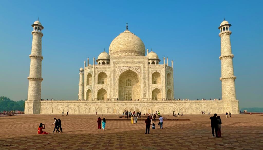 Taj Mahal lit up by the morning sunlight, as seen from the mosque.