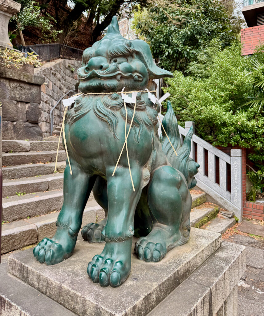 Komainu or Lion-dog statue with the mouth closed symbolizing “un” (the end of all things). At Atago Jinja in Tokyo