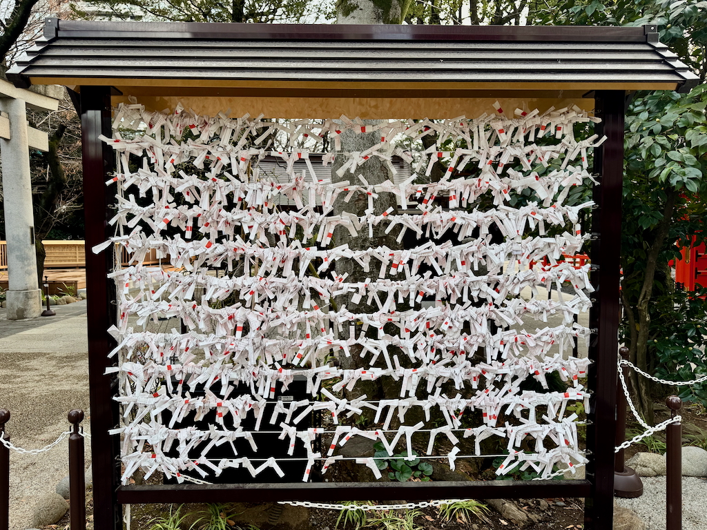 Visitors writes a message or wish on paper and send up the message at Atago Jinja in Tokyo