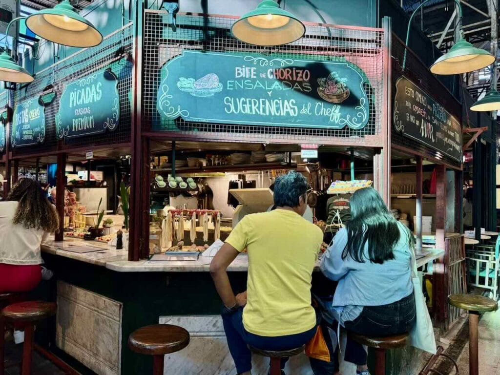 Dining at an Italian food stall in San Telmo food market in Buenos Aires, Argentina 