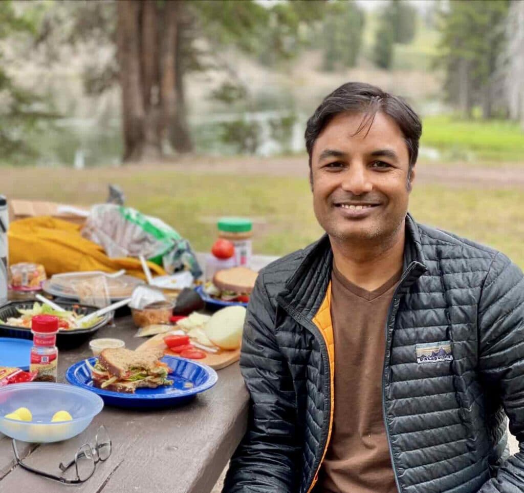 Picnic lunch in Yellowstone National Park during covid pandamic  - sandwich with hummus, nut butter, avocado, lettuce, and veggies