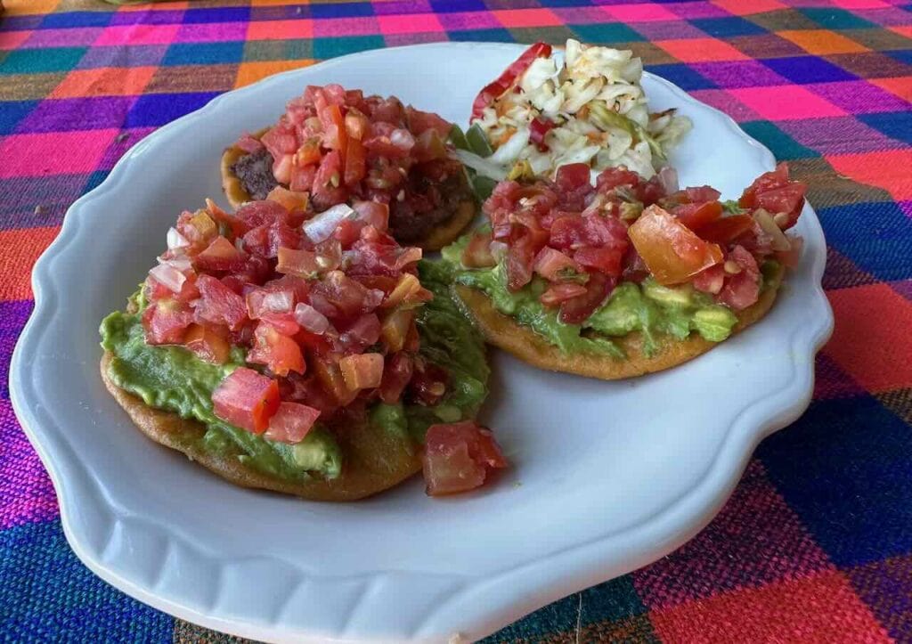 Traditional Mexican dishes like these tostadas tacos with mole, beans, salsa, guacamole etc, can be found across Latin America and the world. They are flavorful, fresh, light and filling at the same time.