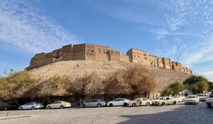 Street-level view of the Erbil Citadel ancient mound and perimeter wall with the old city below, Iraqi Kurdistan