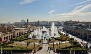 Aerial view of the Erbil Citadel square with fountains and pedestrian plaza below the ancient mound walls, Iraqi Kurdistan