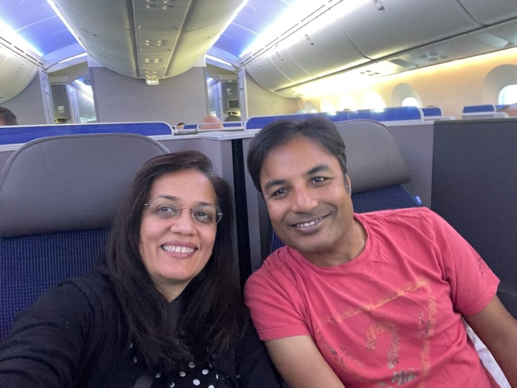 Jyoti and Nirmal settled into United Polaris business class seats before a long-haul flight