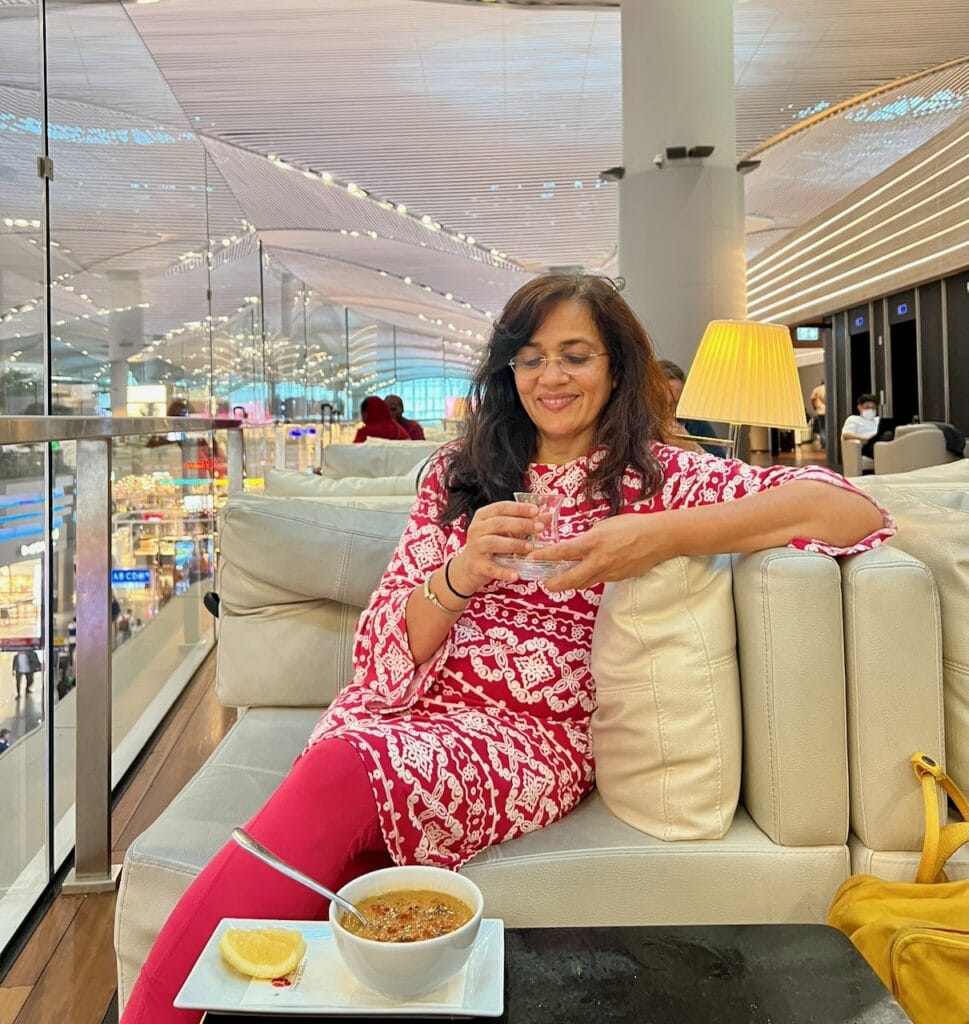 Jyoti Baid eating lentil soup in the Turkish Airlines lounge at Istanbul Airport before a long-haul flight