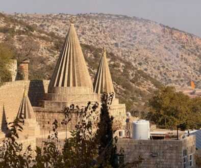 The distinctive conical shrines of the Lalish Yazidi temple rising above the valley walls in the sacred mountain valley, Iraqi Kurdistan