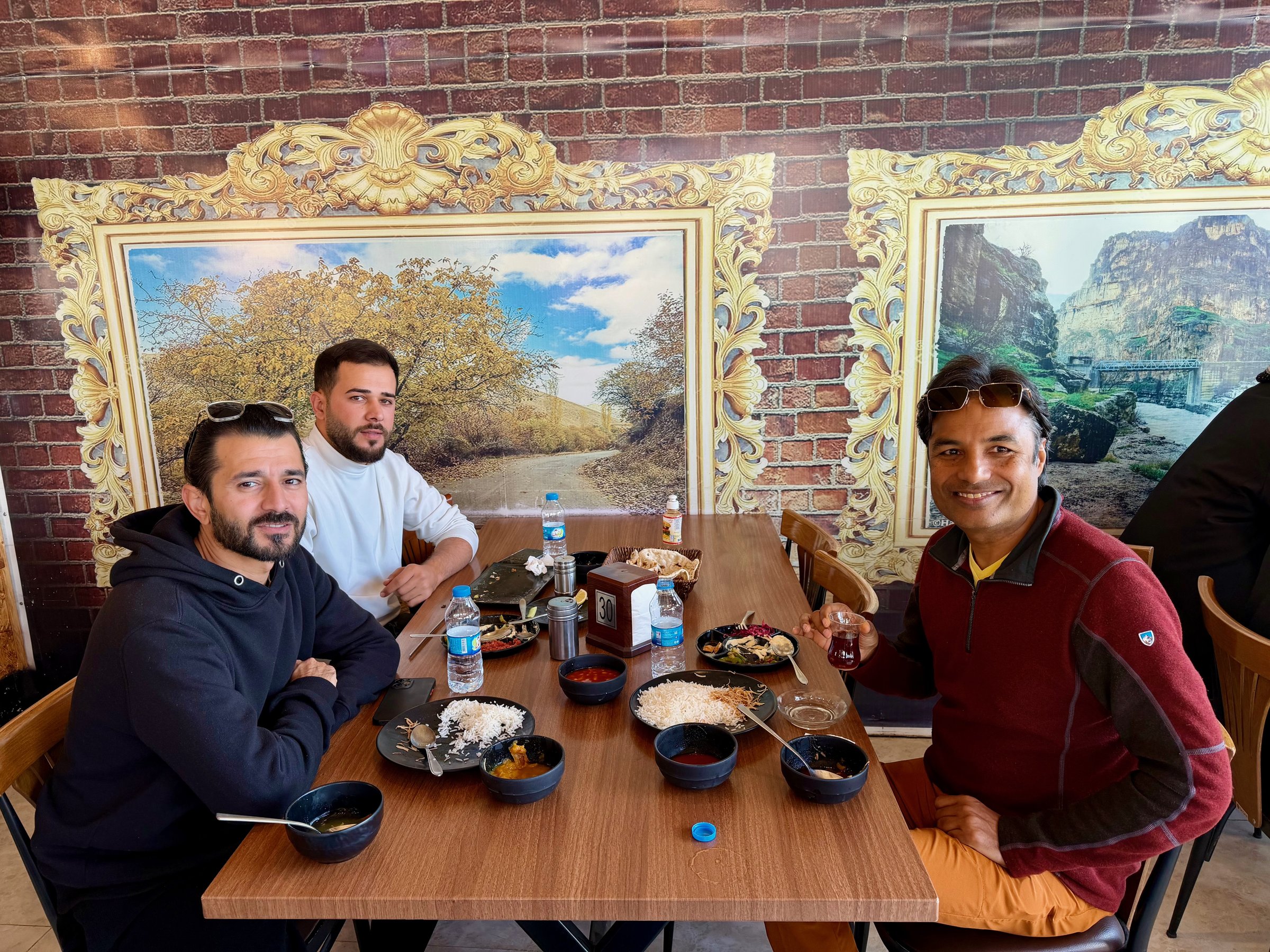 Nirmal and Kurdish guides sharing lunch at a restaurant in Erbil, Iraqi Kurdistan