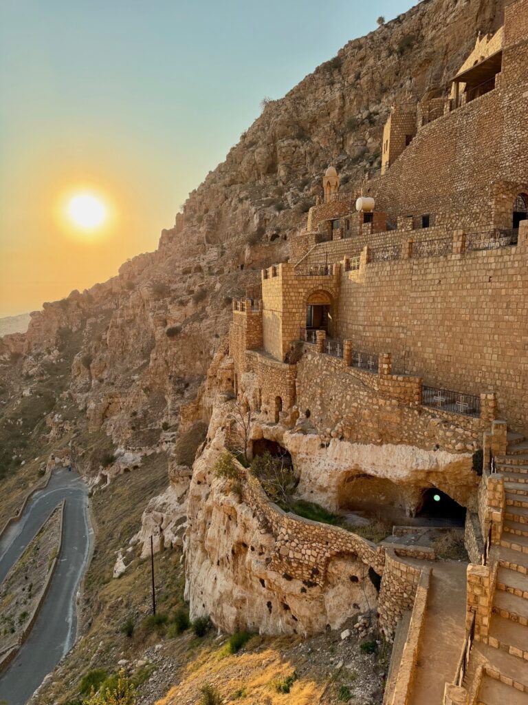 Rabban Hormizd Monastery dramatically set into the cliff face at sunset near Alqosh, northern Iraq